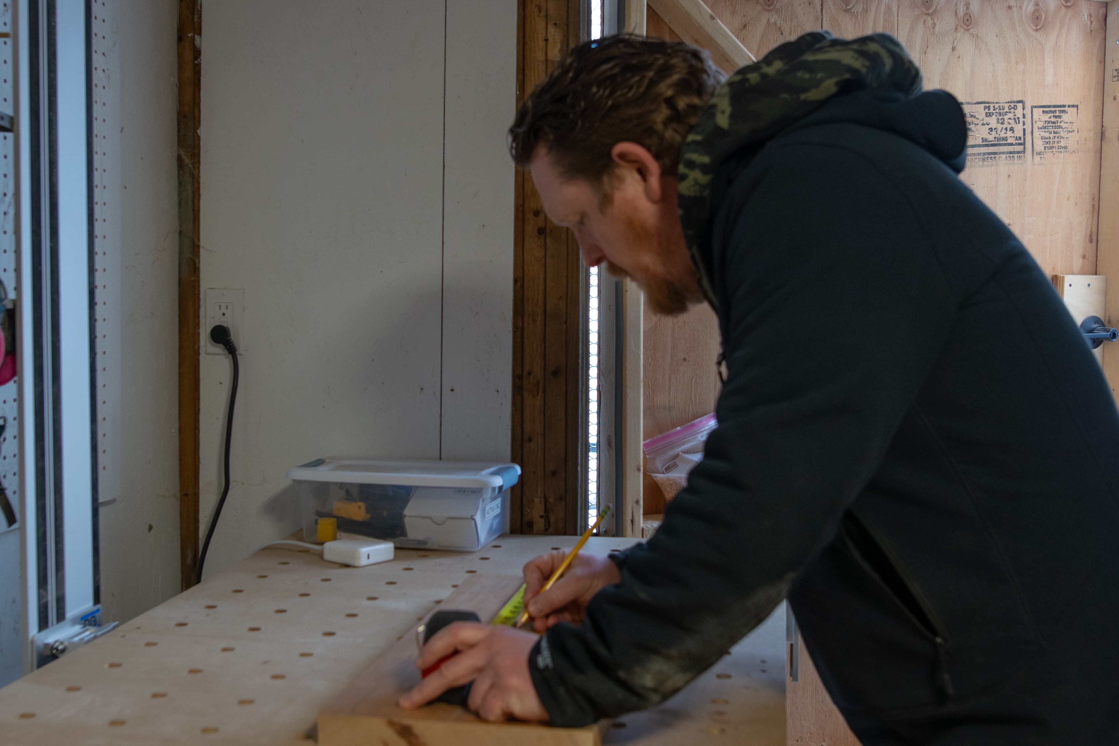 Marking out a board at the bench in the shop
